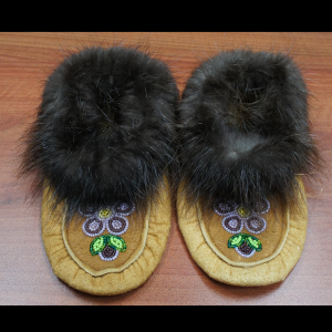 Hand made traditional kids sized moccasins with purple beaded design